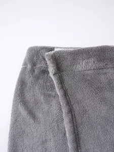 Close-up detail of the soft grey plush fabric and stitching on a wearable bath towel robe.