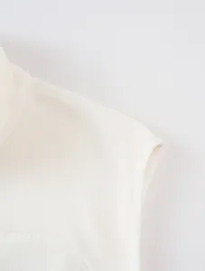 Close-up detail of soft white fleece fabric on a men's stand collar outdoor vest