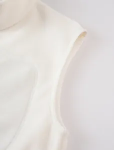 Detail view of cream white fleece vest armhole showing soft fabric texture and seams