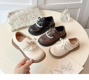 Detail view of children's Mary Jane leather shoes featuring bows and lace trim in three colors.