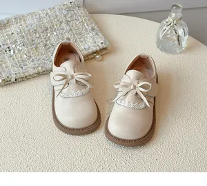 Detail shot of elegant beige girl's princess shoes featuring bow knot and lace trim