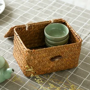 Natural handwoven seagrass storage box with lid for tabletop organization and rustic home decor.