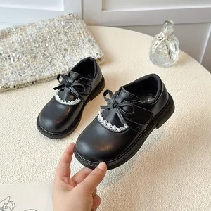 Elegant black princess shoes for girls featuring a cute bow and lace trim detail