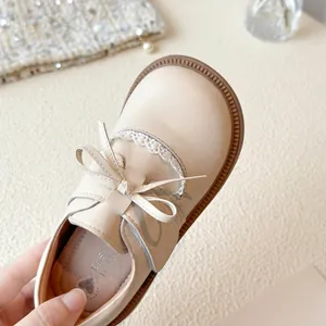Elegant cream girls' princess shoes with delicate bow and lace trim detail