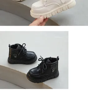 Stylish children's British style Martin boots in black and beige for the winter season.