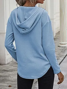 Gedetailleerd achteraanzicht van een casual lichtblauwe wafelgebreide hoodie met ronde zoom