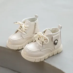Stylish beige toddler Martens boots with side zipper and lace-up design for winter
