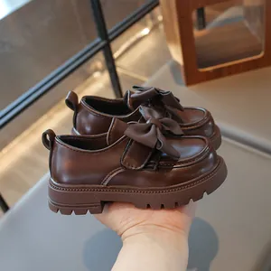Close-up view of elegant brown girls' princess loafers with a stylish bow detail