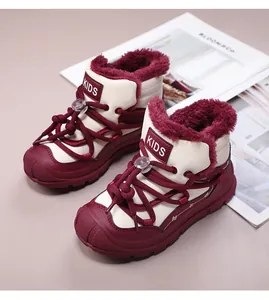 Detail view of burgundy and cream kids' winter boots with thick faux fur lining