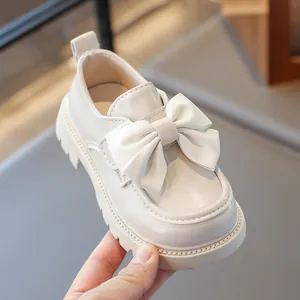 Elegant beige girls' princess shoes with large bow and soft non-slip sole for toddlers.