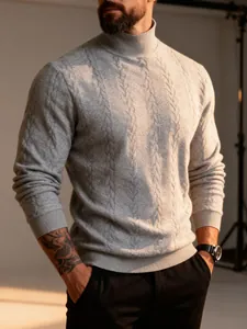 Close-up of men's grey high-collar thick cable-knit sweater showing detailed texture