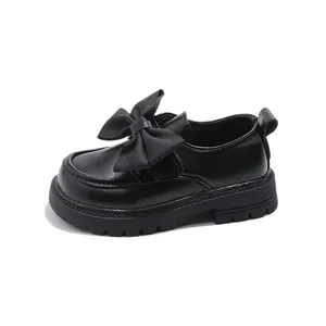 Elegant black girls' princess leather shoes featuring a large bow and soft rubber sole