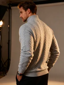 Detailed view of men's grey cable knit turtleneck sweater with warm texture