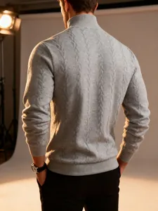 Macro detail of men's grey cable-knit turtleneck sweater showing thick warm texture