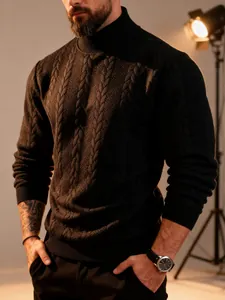 Close-up of a men's black cable knit turtleneck sweater with thick warm texture.