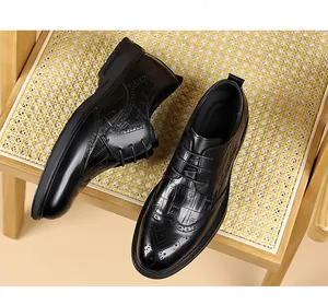 Close-up of black leather brogue shoes featuring crocodile texture and wingtip design