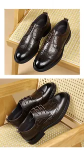 Detail view of dark brown men's business dress shoes with crocodile texture and brogue pattern