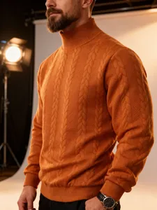 Detail of men's orange cable-knit turtleneck sweater showing texture and fit