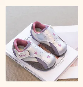 Close-up of girls' silver metallic sneakers featuring star patterns and easy velcro straps.