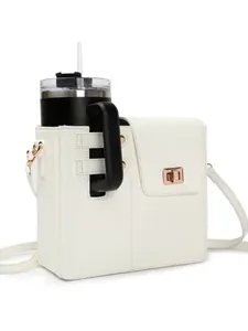 Detail view of stylish white crossbody bag with dedicated tumbler holder and gold buckle