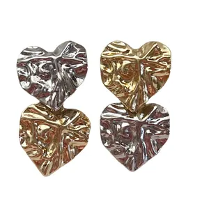 Unique heart-shaped stud earrings featuring a textured crumpled finish in gold and silver.