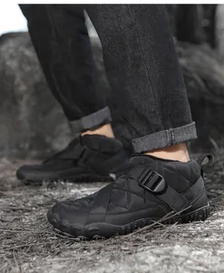 Detail side view of black quilted waterproof outdoor snow boots with buckle strap