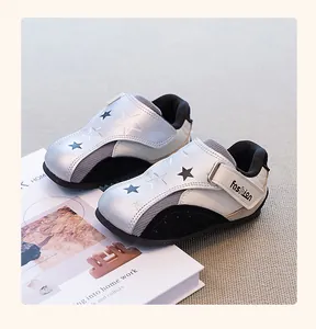 Detail view of silver and white children's casual sneakers with star patterns