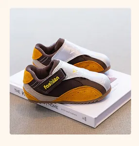 Close-up of stylish children's casual sneakers with yellow accents and velcro strap