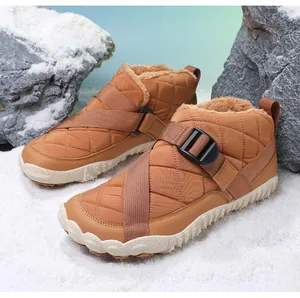 Close-up of brown waterproof snow boots with warm fleece lining in a snow scene