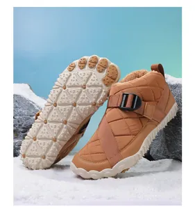 Detailed view of brown quilted winter snow boots featuring a textured anti-slip rubber sole