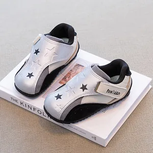 Stylish silver children's casual sneakers featuring black star patterns and soft rubber soles