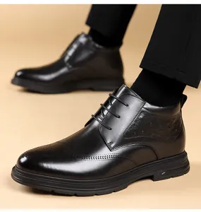 Close-up detail of black formal high-top leather shoes featuring elegant brogue patterns