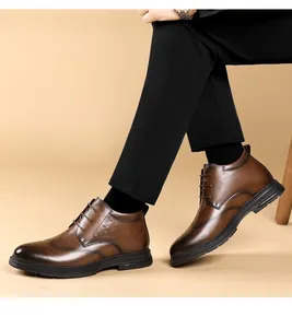 Close-up of brown men's leather high-top boots worn with black trousers and socks