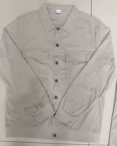 Front view of men's beige corduroy casual jacket with utility chest pockets and buttons