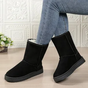 Detail view of black women's snow boots with warm faux fur lining and thick soles