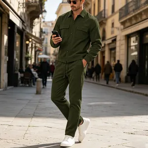 Men's olive green corduroy two-piece set styled in a European street setting.