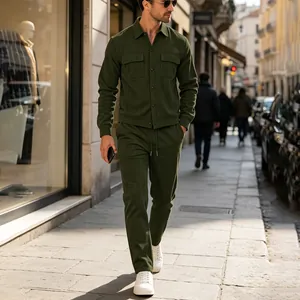 Full-body street style shot of a man wearing an olive green corduroy two-piece set