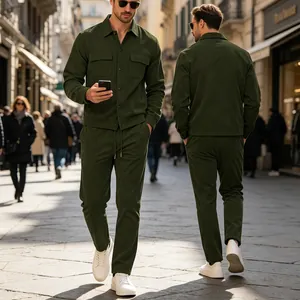 Detailed view of men's olive green corduroy utility jacket and trousers set on street
