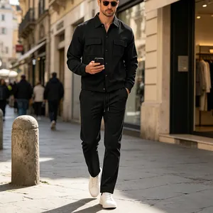 Lifestyle view of men's black corduroy casual set with multi-pocket jacket and pants