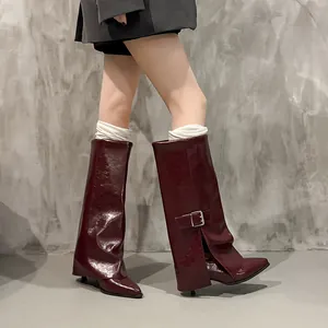 Detailed view of burgundy high-shine trouser boots with side buckle and kitten heel