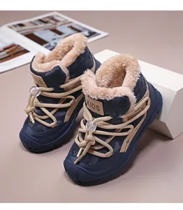 Close-up of children's blue camouflage snow boots with thick warm faux fur lining
