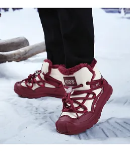 Detailed view of red fleece-lined kids snow boots on snow