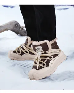 Close-up of kids warm snow boots with thick faux fur lining in a snowy outdoor setting