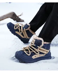 Detailed view of children's navy camouflage snow boots with warm faux fur lining