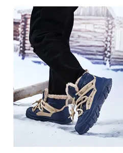 Detail view of navy blue kids fleece-lined snow boots worn in a snowy outdoor setting