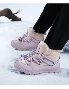 Detail of pink and purple kids snow boots with warm faux fur lining for winter