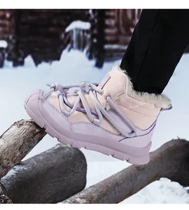 Detailed macro view of pink children's snow boots with thick warm fur lining on snow