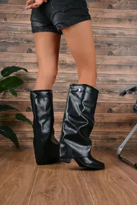 Stylish black slouchy fold-over knee high boots with chunky heel and buckle detail