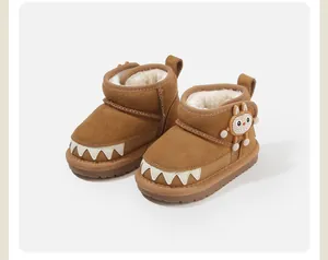 Close-up of brown toddler snow boots with monster teeth design and fleece lining
