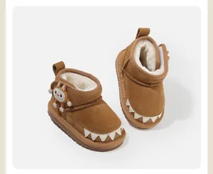 Detail view of brown toddler snow boots with plush lining and cute monster accent.